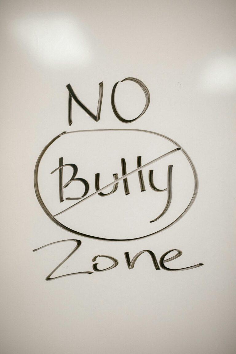 A handwritten motivational message on a whiteboard promoting a no-bullying zone.