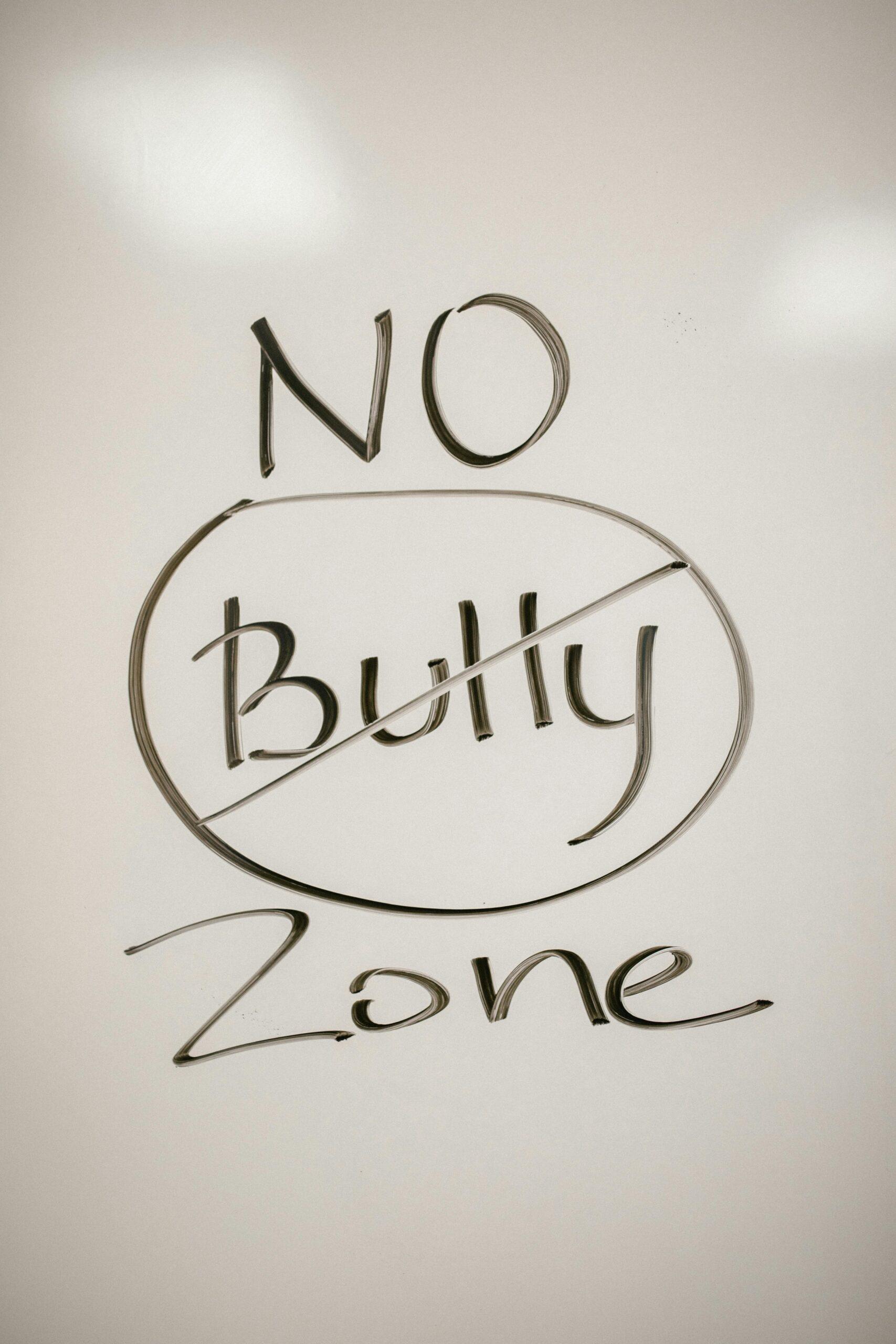 A handwritten motivational message on a whiteboard promoting a no-bullying zone.