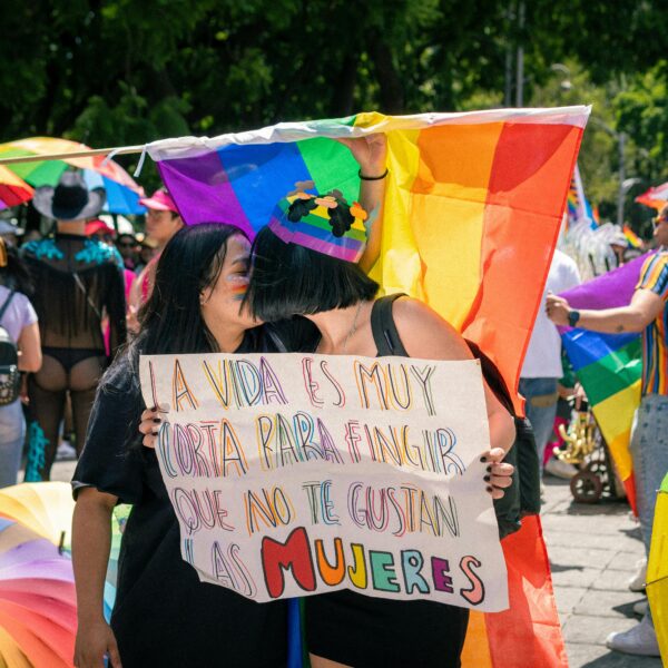 Colorful pride parade capturing joyful moments and LGBTQ+ solidarity in a sunny outdoor setting.